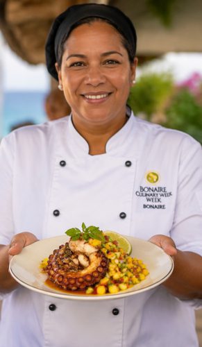 Chef on Bonaire holding a local dish