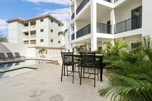 Bonaire Beach Apartments 4 with a mature palm garden and a refreshing shared pool